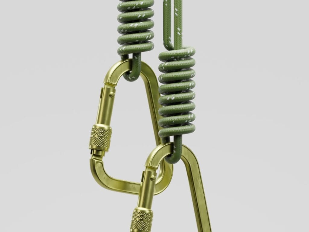 Two carabiners attached to green ropes